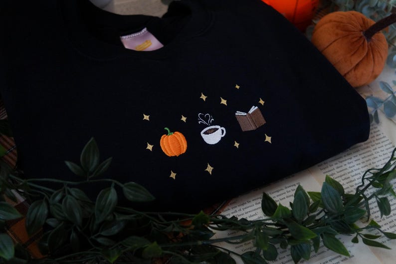 Autumn Icons Pullover Embroidered Jumper   Autumnal Sweatshirt   Fall Inspired Sweater   Pumpkin Coffee Cup And Book Autumn Design 1725954808885.jpg