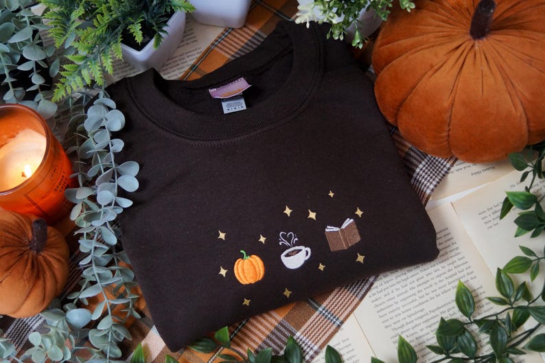 Autumn Icons Pullover Embroidered Jumper   Autumnal Sweatshirt   Fall Inspired Sweater   Pumpkin Coffee Cup And Book Autumn Design 1725954809016.jpg