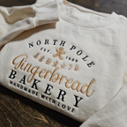 North Pole Gingerbread Bakery Handmade With Love Embroidered Sweatshirt 1728371583387.png