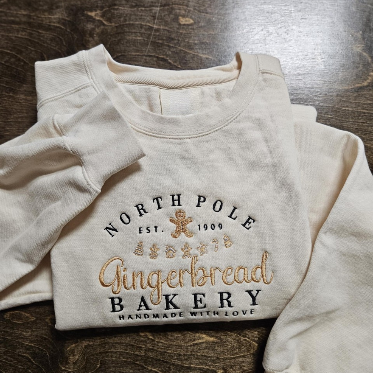 North Pole Gingerbread Bakery Handmade With Love Embroidered Sweatshirt 1728371583439.png