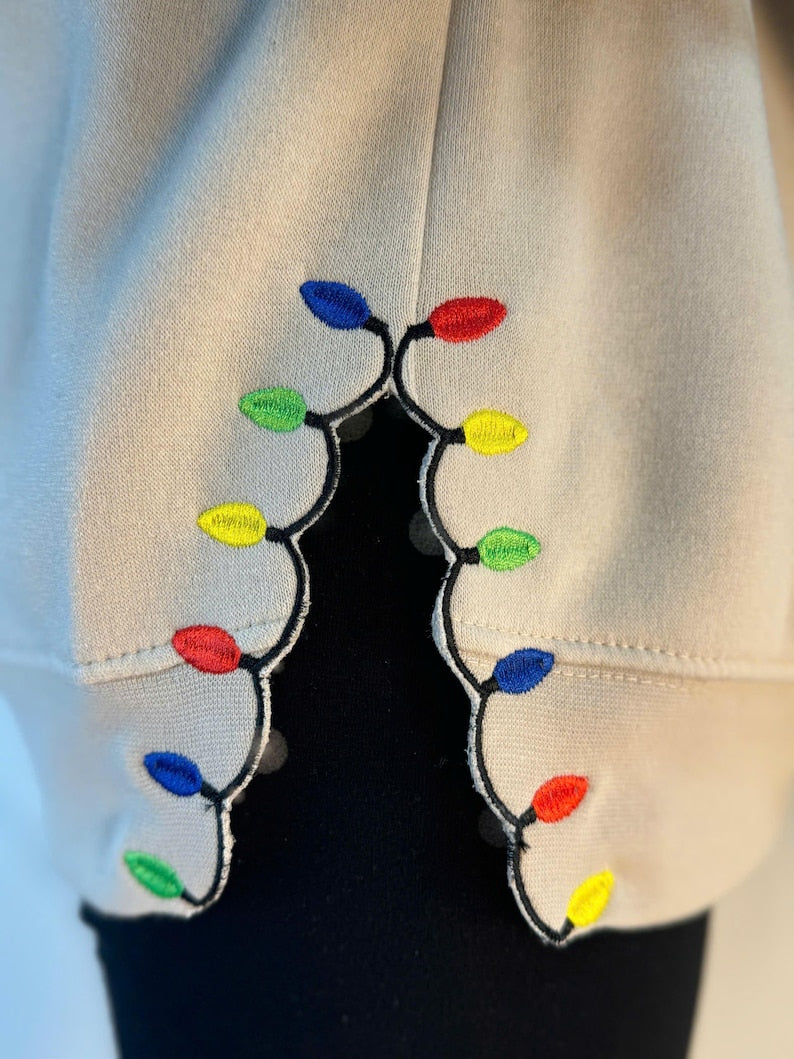 We Can Leave The Christmas Lights Up Til January Sweatshirt  Embroidered Christmas Lights Cut Hem Sweatshirt Side Bow Appliqu Sweatshirt 1730362691885.jpg