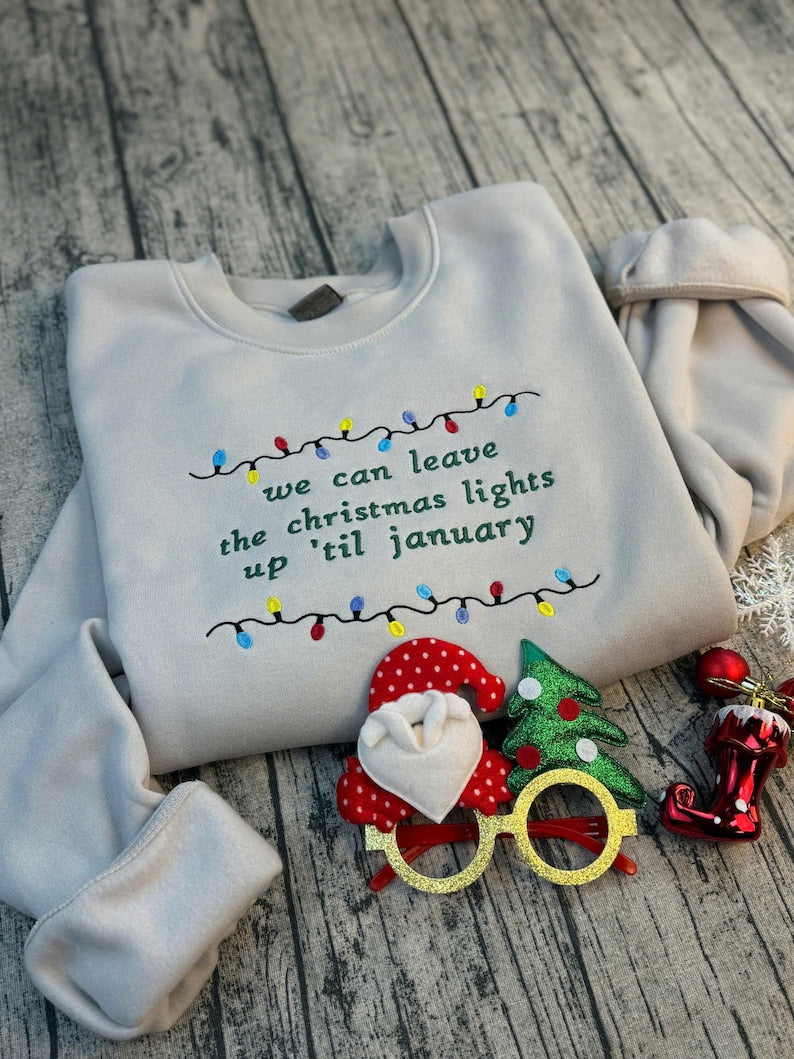 We Can Leave The Christmas Lights Up Til January Sweatshirt  Embroidered Christmas Lights Cut Hem Sweatshirt Side Bow Appliqu Sweatshirt 1730362691904.jpg