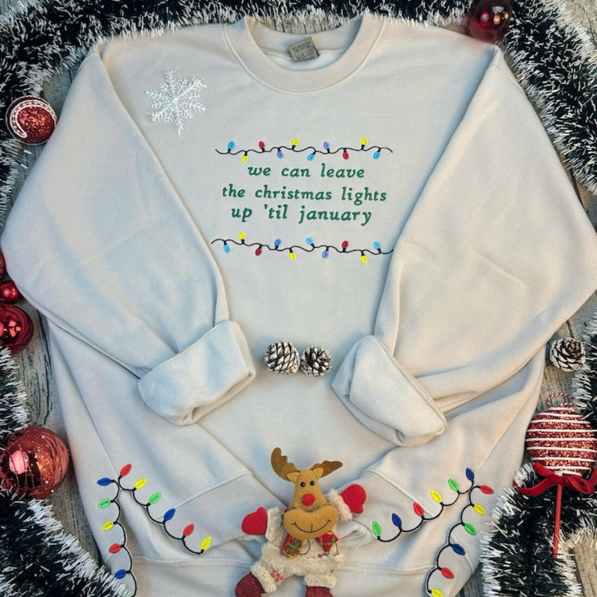 We Can Leave The Christmas Lights Up Til January Sweatshirt  Embroidered Christmas Lights Cut Hem Sweatshirt Side Bow Appliqu Sweatshirt 1730362692487.png