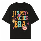 In My Teacher Era Graphic Tee - Retro Style with Happy Faces and School Elements, Perfect for Educators - T-shirt 1758093388870.jpg
