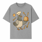 Chef Pigeon Serving Cake Design T-Shirt | Cute Bird Baking Graphic Tee | Fun Cooking Gift for Bird Lovers & Bakers - T-shirt 1758181728008.jpg