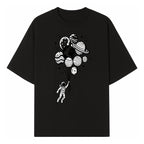 Astronaut Holding Planet Balloons Graphic T-Shirt | Space Adventure Design | Galaxy-Themed Apparel for Kids and Adults - T-shirt 1758273116908.jpg