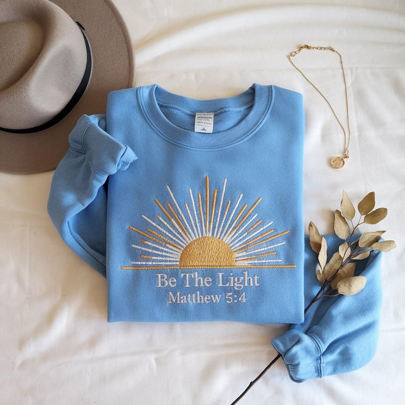 Be The Light Matthew 54 Sweatshirt   Embroidered Christian Sun Rays Hoodie Inspirational Bible Verse Cozy Faith Gift For Women And Men 1761641413152.jpg