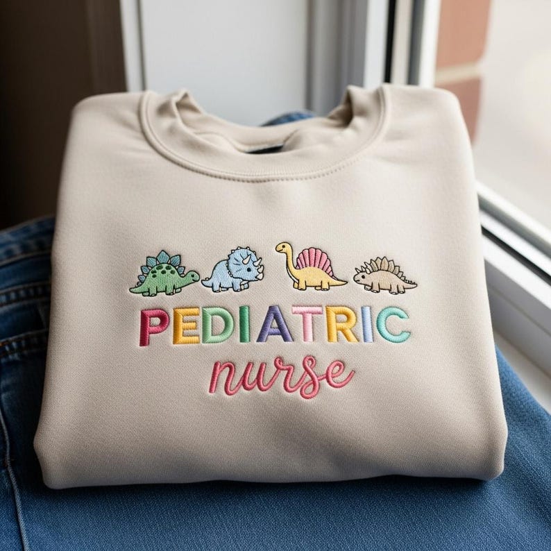 Embroidered Dinosaur Pediatric Nurse Sweatshirt Nurse Lovers Hoodie Peds Sweater For Her Rn Dino Hoodie Nurse Graduation Gift 1763348726507.jpg