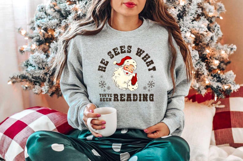 He Sees What Youve Been Reading Santa Sweatshirt Funny Bookish Christmas Santa Sweater Book Lover Gift Xmas Sweatshirt Gift For Her 1763606759412.jpg