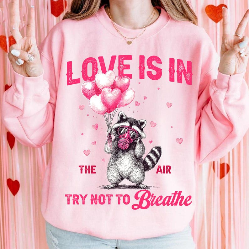 Love Is In The Air Try Not To Breathe Shirt Funny Raccoon Valentine Shirt Sarcastic Anti Love Shirt Shirt Feral Raccoon Humor Shirt 1767674078864.png