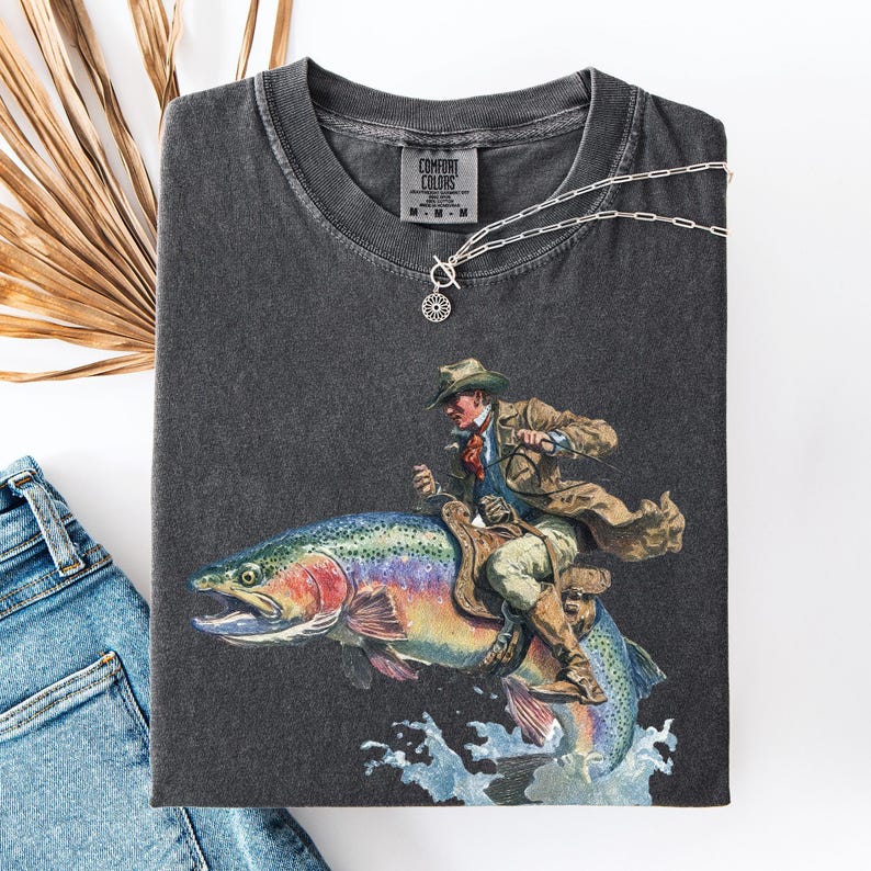 Cowboy Riding Rainbow Trout T-Shirt - Genuine Comfort Colors - Cowboy Fishing Club Rodeo Graphic Tee - Unique Gift For Family d41c517b-e5c8-4daf-bc82-5c3e81e60cc5-mnr1.jpg