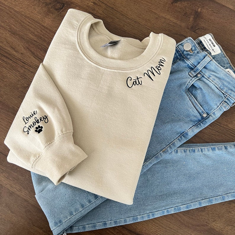 Cat Mom Embroidered Sweatshirt, Custom Mama Shirt With Pet Names, Cat Mom On Neckline, Paw On Sleeve, Gift For Cat Mom, Mother's Day Gift il_794xN.4785988162_s3az.jpg?v=1743397328