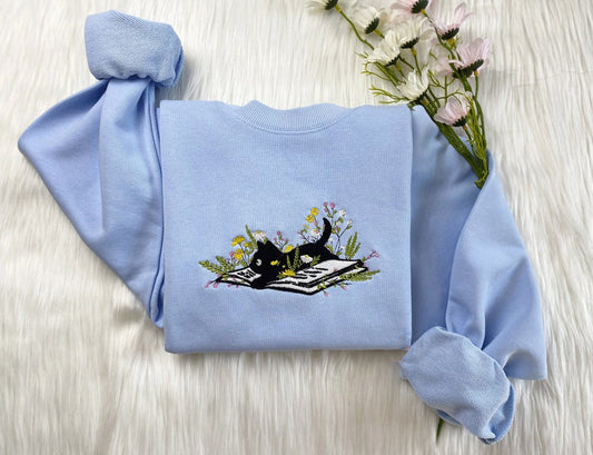 Embroidered Cute Cat Lying On Book With Flower Sweatshirt | Flower With Cat Embroidered Hoodie | Book Lover T-Shirt | Crew Neck Sweatshirt