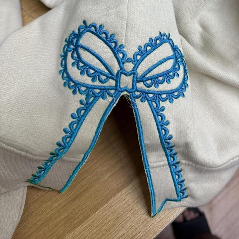 Custom Nana Est Embroidered Christmas Bow Embellished Shirt, Colorful Custom Side Bow Cut-Out Sweatshirt, Christmas Gift Hoodie il_794xN.6377357500_l11y.jpg