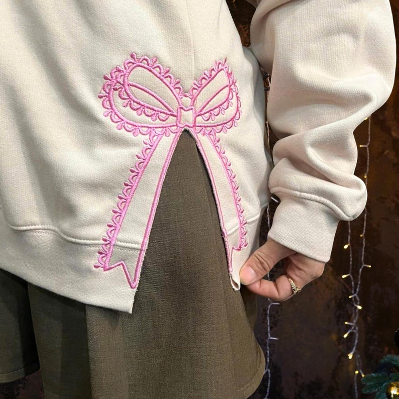 Custom Nana Est Embroidered Christmas Bow Embellished Shirt, Colorful Custom Side Bow Cut-Out Sweatshirt, Christmas Gift Hoodie il_794xN.6377359852_e0o1.jpg