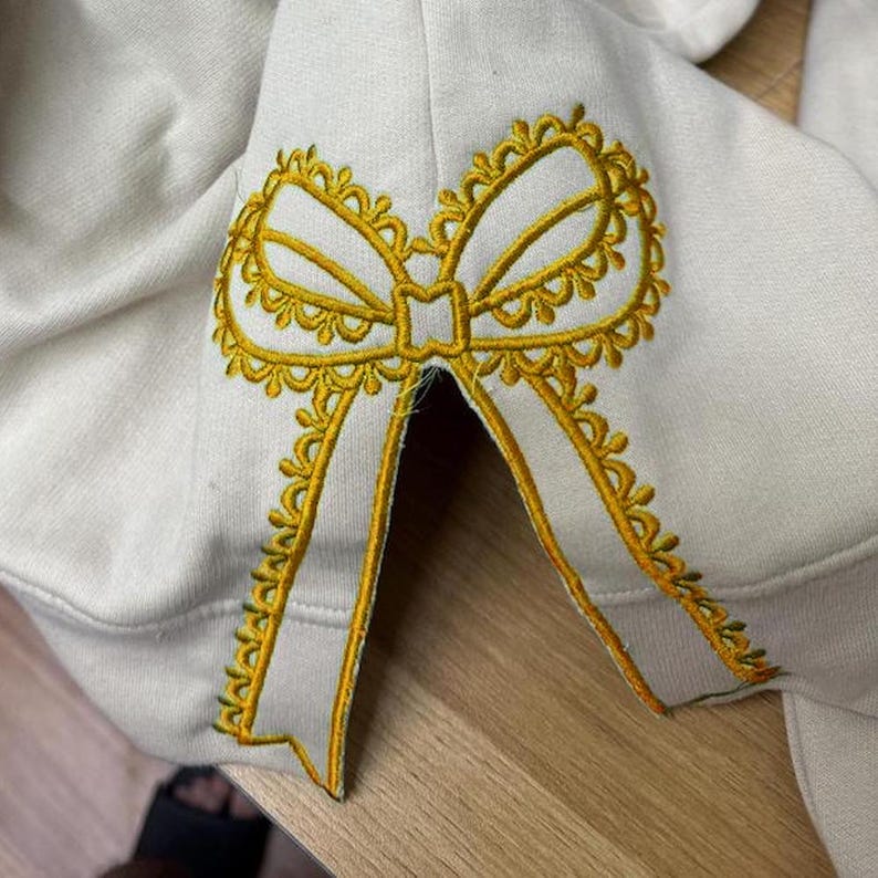 Custom Nana Est Embroidered Christmas Bow Embellished Shirt, Colorful Custom Side Bow Cut-Out Sweatshirt, Christmas Gift Hoodie il_794xN.6377361830_ubsb.jpg