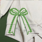 Custom Nana Est Embroidered Christmas Bow Embellished Shirt, Colorful Custom Side Bow Cut-Out Sweatshirt, Christmas Gift Hoodie il_794xN.6425445269_k04i.jpg