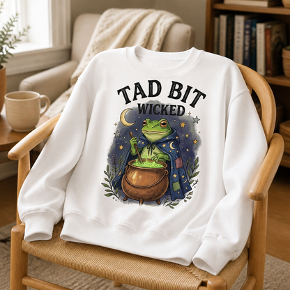 Tad Bit Wicked Frog Witch Sweatshirt – Whimsical Cauldron Halloween Sweater, Cute Spooky Season Gift for Her mockup-product-6a8e522f6874ebd7ebdd7117.png